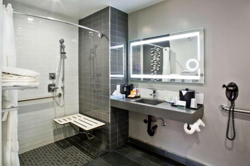 a bathroom with a sink and a shower at Bay Area Inn & Suites in Hayward