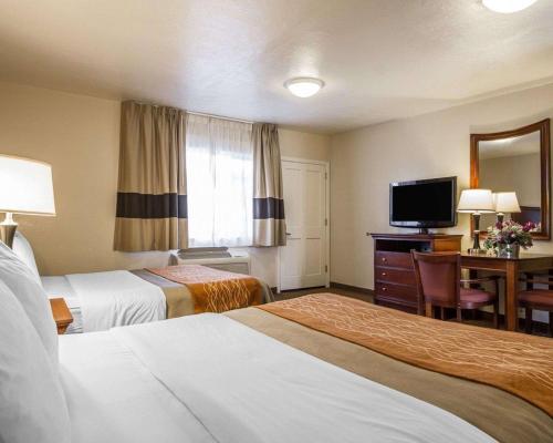 a hotel room with two beds and a television at Blu Pacific Hotel in Monterey