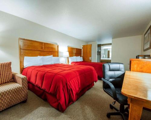 a hotel room with two beds and a chair at Sea Drift Inn in Eureka