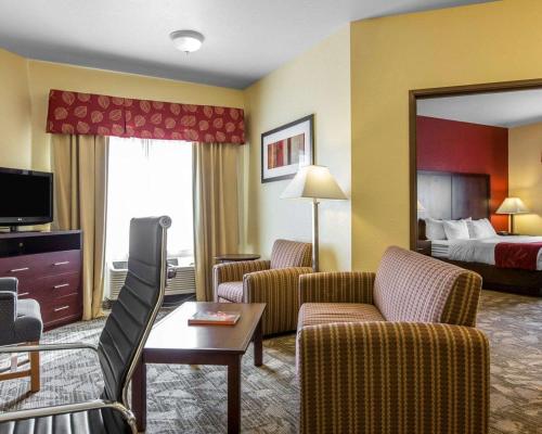 a hotel room with a bed and a living room at Comfort Suites Palm Desert I-10 in Palm Desert