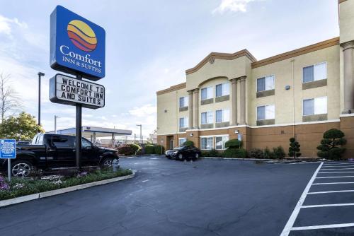 a large white building with a sign on the side of it at Comfort Inn & Suites Sacramento – University Area in Sacramento