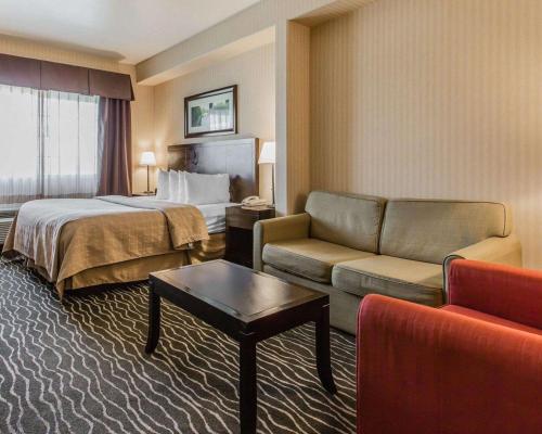 a hotel room with a bed and a couch at Quality Inn Rosemead-Los Angeles in Rosemead