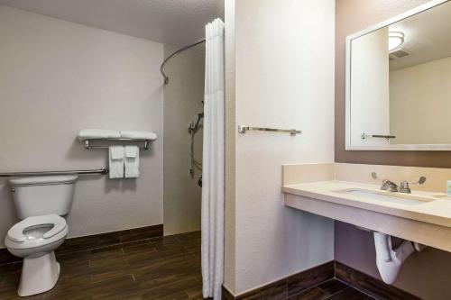 a bathroom with a toilet and a sink and a mirror at Comfort Inn Los Angeles near Hollywood in Los Angeles