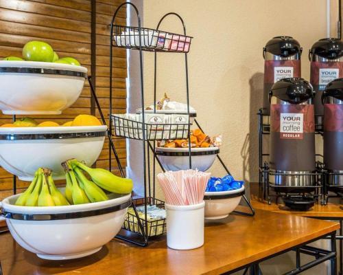 a table with bowls of fruit on top of it at Quality Inn Lone Pine near Mount Whitney in Lone Pine