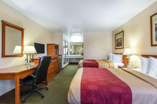 a hotel room with two beds and a desk at Econo Lodge Inn & Suites Riverside - Corona in Riverside