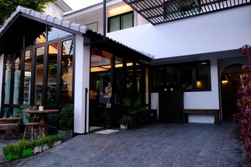 a restaurant with glass doors and a patio at Baan Lung Poshtel in Chiang Mai