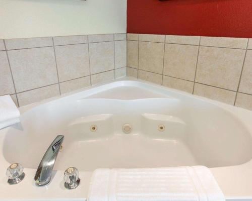a white bath tub with a faucet in a bathroom at Comfort Suites Palm Desert I-10 in Palm Desert