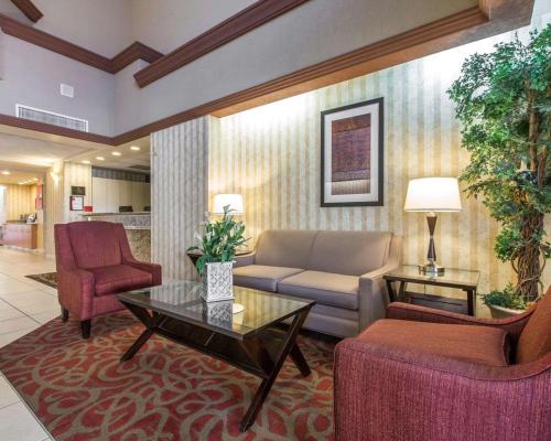 a living room with a couch and two chairs at Comfort Suites Palm Desert I-10 in Palm Desert