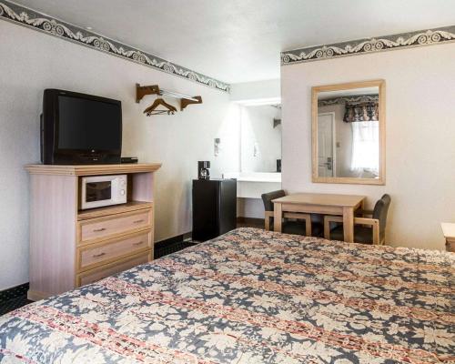 a hotel room with a bed and a television at Rodeway Inn Monterey Near Fairgrounds in Monterey