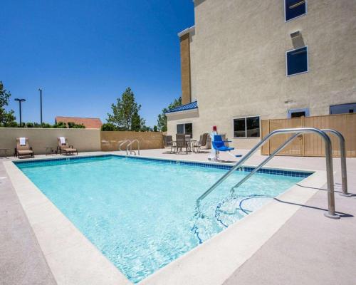 a large swimming pool in a building with aitamin at Comfort Suites Victorville-Hesperia in Victorville
