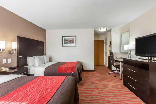 a hotel room with two beds and a flat screen tv at Comfort Inn Los Angeles near Hollywood in Los Angeles