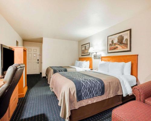 a hotel room with two beds and a chair at Comfort Inn & Suites Salinas in Salinas