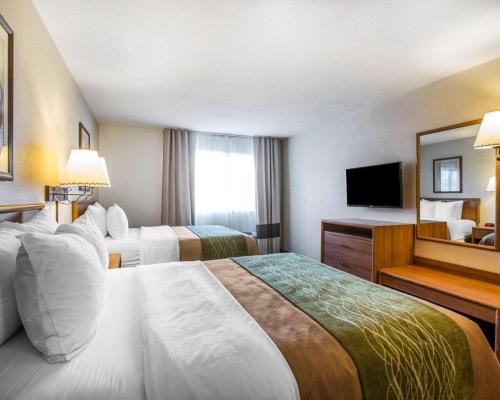a hotel room with two beds and a television at Quality Inn Lone Pine near Mount Whitney in Lone Pine