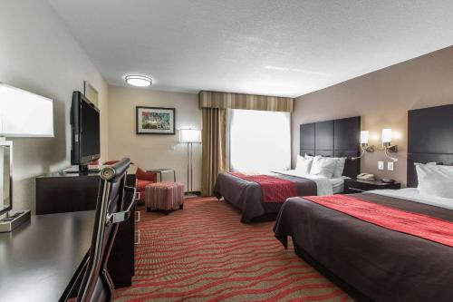a hotel room with two beds and a flat screen tv at Comfort Inn Los Angeles near Hollywood in Los Angeles
