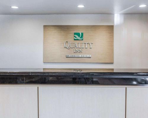 a sign for a quality inn on a wall at Quality Inn Rosemead-Los Angeles in Rosemead