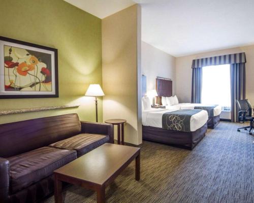 a hotel room with a bed and a couch at Comfort Suites in Turlock