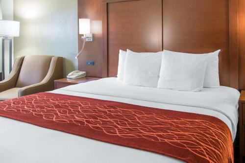 a bed in a hotel room with a red blanket at Comfort Inn & Suites San Francisco Airport North in South San Francisco