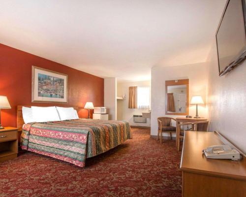 a hotel room with a bed and a desk at Rodeway Inn Fallbrook Downtown in Fallbrook