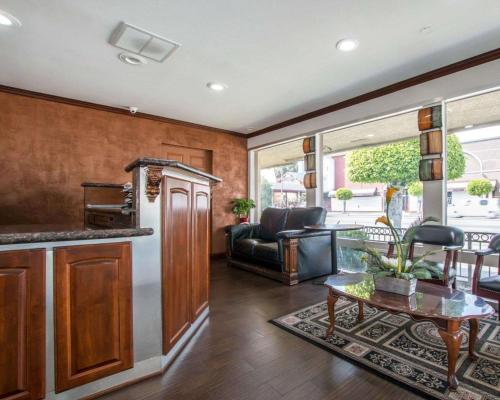 a kitchen and living room with a couch and a table at Rodeway Inn Los Angeles Convention Center in Los Angeles