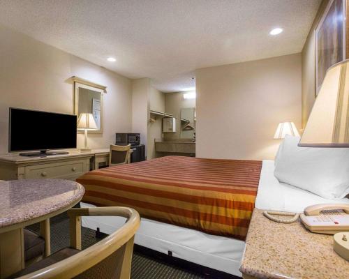 a hotel room with a bed and a television at Rodeway Inn Santee San Diego East in Santee