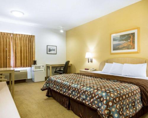 a hotel room with a bed and a desk at Pacific Coast Inn in Watsonville