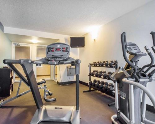 a gym with two treadmills and exercise machines at Comfort Inn in Bathurst