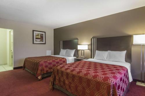 A bed or beds in a room at Econo Lodge Inn and Suites Lethbridge