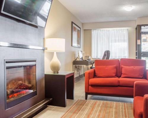 a living room with a couch and a fireplace at Comfort Inn in Brantford