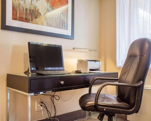 a desk with a laptop computer on top of it at Comfort Inn in Brantford