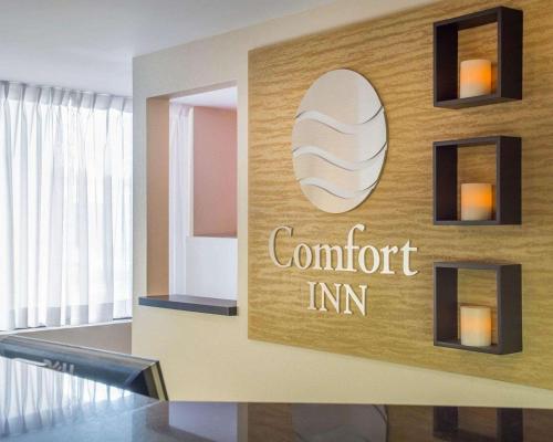 a sign for a comfort inn on a wall at Comfort Inn in Brantford