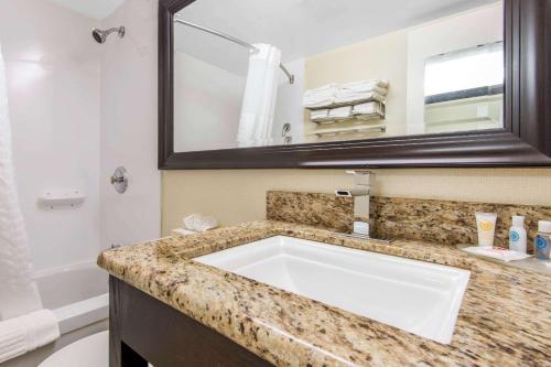 a bathroom with a sink and a mirror at Comfort Inn in North Bay