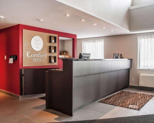 an office with a confident inc sign on a red wall at Comfort Inn in Orillia