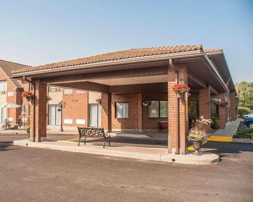 a pavilion with a bench in front of a building at Comfort Inn in Orillia