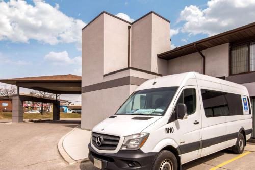 a white van parked in front of a building at Comfort Inn Airport West in Mississauga