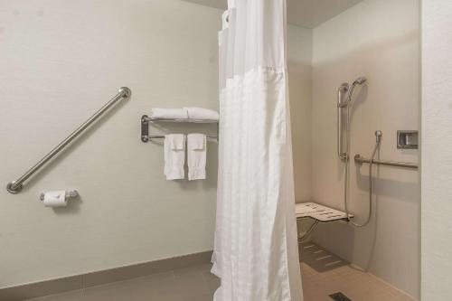 a bathroom with a shower curtain in a hotel room at Comfort Inn in Oshawa