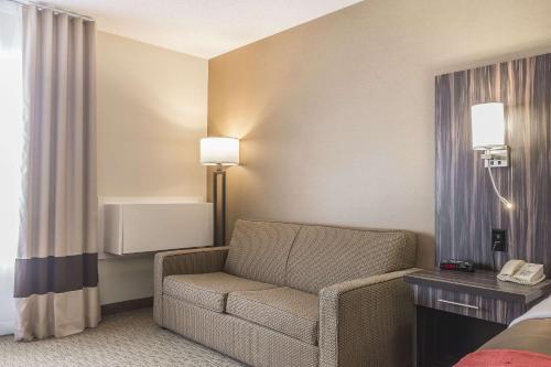 a hotel room with a chair and a bed at Comfort Inn Trenton in Trenton