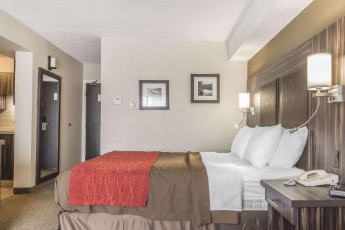 a hotel room with a bed and a telephone at Comfort Inn Trenton in Trenton