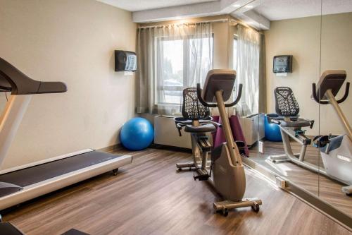 a gym with treadmills and exercise equipment in a room at Comfort Inn Aeroport in Dorval