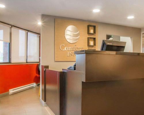 an entrance to a company office with a sign on the wall at Comfort Inn Winnipeg South in Winnipeg