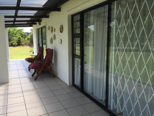 a screened in porch with chairs on a house at Blue Skies Country House in Lorraine