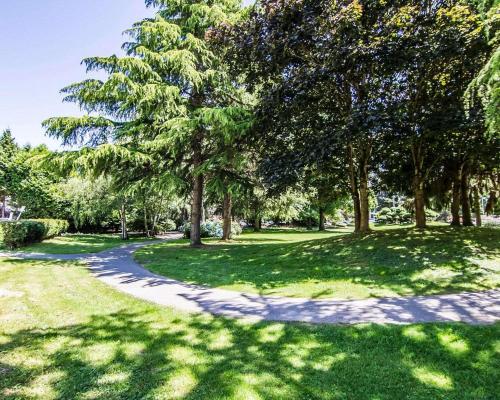 a path in a park with trees and grass at Comfort Hotel Vancouver Airport in Richmond
