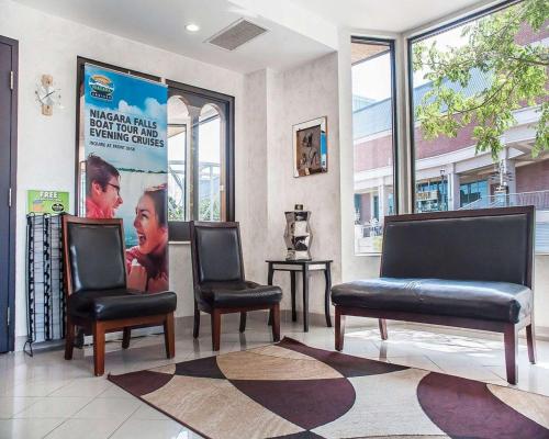 a waiting room with two chairs and a poster at Quality Hotel Fallsview Cascade in Niagara Falls