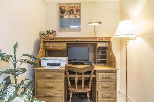 an office with a desk with a computer and a lamp at Econo Lodge Inn & Suites Saint John in Saint John