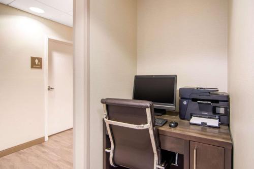 an office with a desk with a computer and a printer at Comfort Inn & Suites in Red Deer