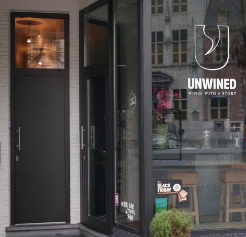 a store front with a black door and a window at Margaretha's Room in Mechelen