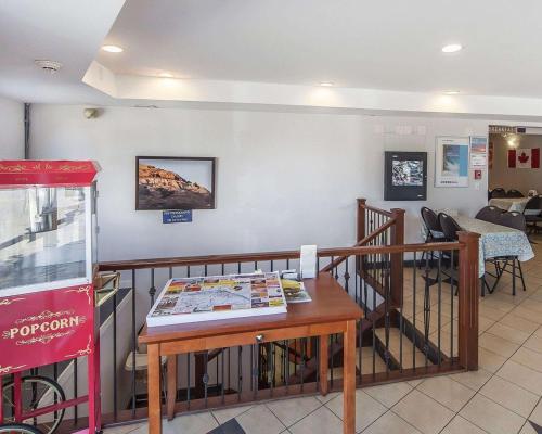 a lobby with a table with a magazine on it at Econo Lodge Inn & Suites Drumheller in Drumheller