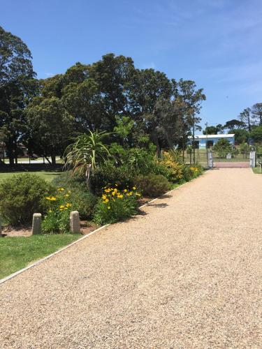 a path in a park with flowers and trees at Blue Skies Country House in Lorraine