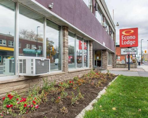a store with a sign on the side of a building at Econo Lodge Downtown in Ottawa