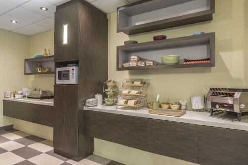 a kitchen with a counter with food on it at Quality Hotel & Conference Centre in Campbellton