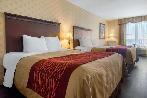 a hotel room with two beds and a window at Comfort Inn & Suites in Lévis